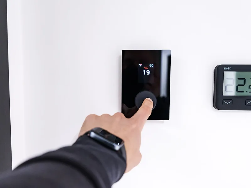 Setting a smart heating thermostat on the wall