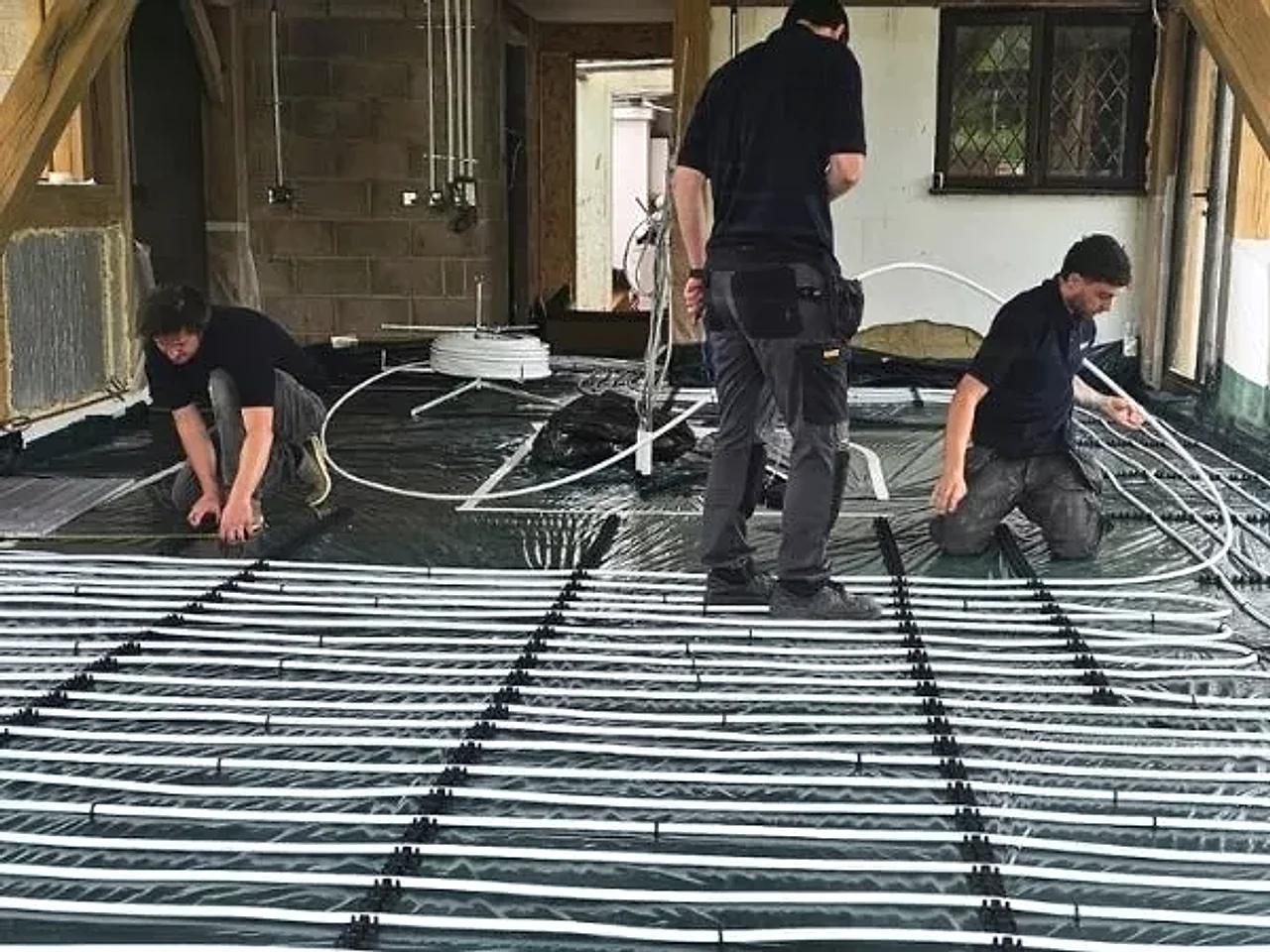 The Watertech team laying underfloor-heating pipe loops on a recent Leicester install